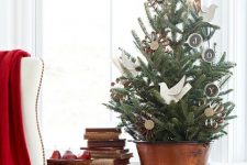 a vintage rustic tabletop Christmas tree with paper birds, chalkboard ornaments and cardboard ones is a lovely and eays idea