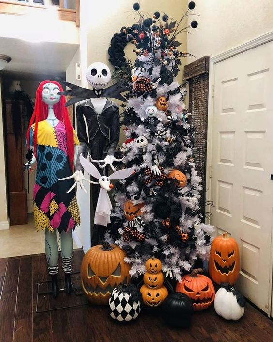 a white Christmas tree decorated with Halloween pumpkins, black branches and eyeballs, bats and other stuff can be a fit for Halloween, too