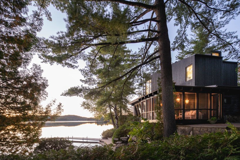 01 This rustic log cabin in Canada got an extension on top, it is clad with black timber to merge with nature