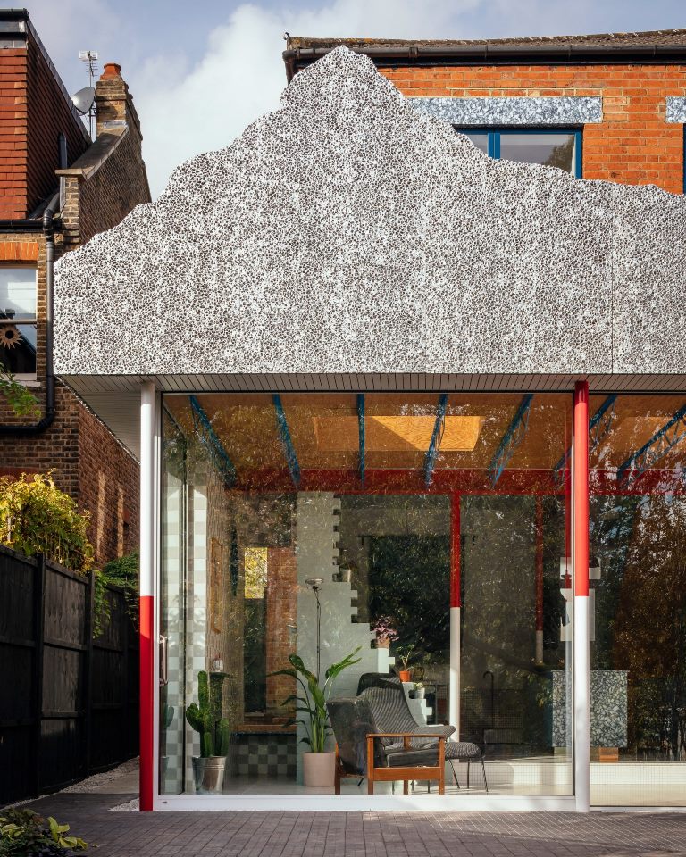 This unique house extension is topped with a fake mountain that reminds of a fake Disneyland mountain