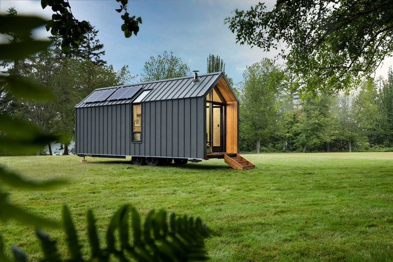 The house features a simple gable roof and several windows that brign light in