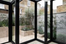 03 Glass walls offer much natural light and cool views of a private garden clad in terrazzo