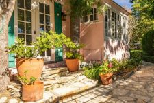 03 The house is surrounded by potted plants and blooms