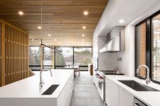 a modern kitchen with a stylish wooden ceiling