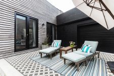 03 There are also some loungers, pretty pastel blue upholstery and linens and potted greenery and blooms