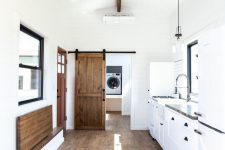 05 The bathroom is hidden behind a wooden barn door that’s both beautiful and space-efficient