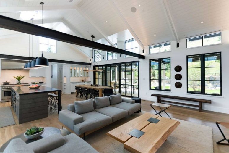 The living room is done with contemporary furniture and is built around a cozy fireplace