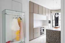 a super stylish and super sall closet near a kitchen