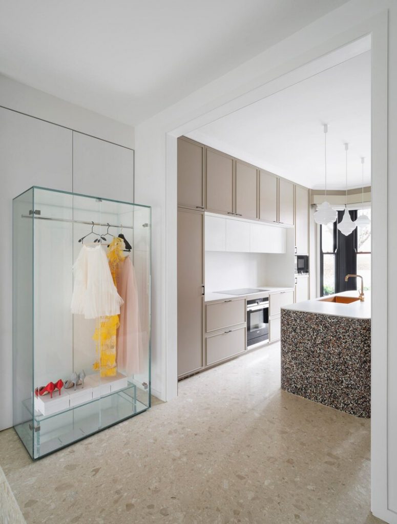 a super stylish and super sall closet near a kitchen