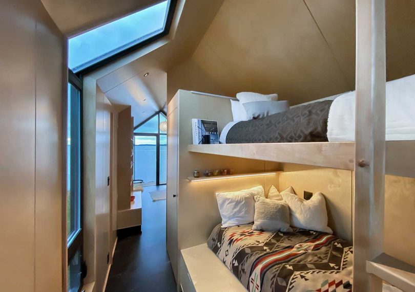 Here you may see two sleeping spaces with lights and a window with a skylight