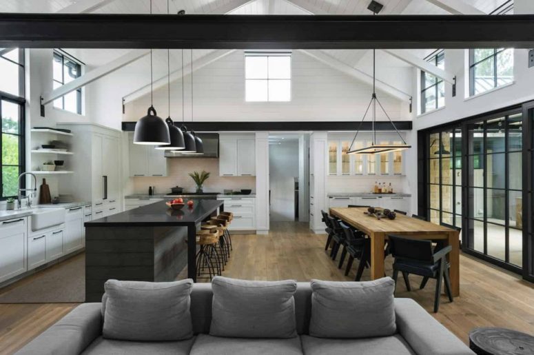 The kitchen island and dining table are parallel to one another and complement each other seamlessly