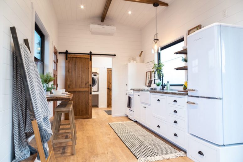 The kitchen is well-equipped and has generous storage as well as a farmhouse sink