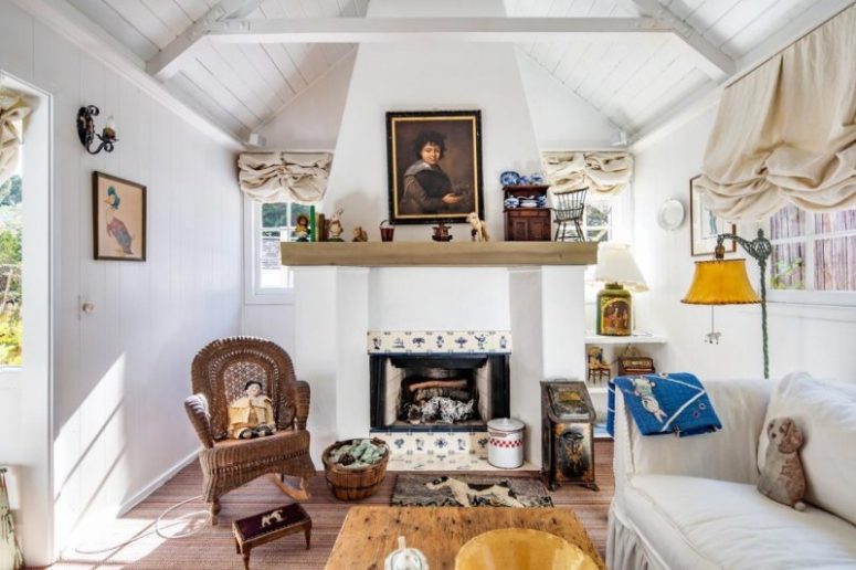 a living room with a cozy tiled fireplace