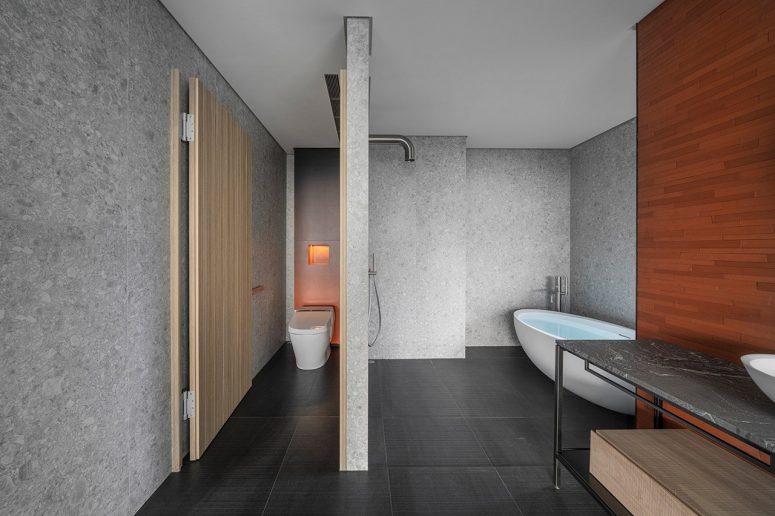The bathrooms continue the same clean minimalist aesthetic and a gorgeous material palette