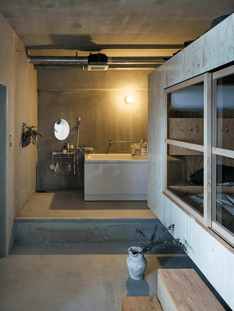 The bathroom is partly opened but partly hidden by the cube, which allows better ventilation