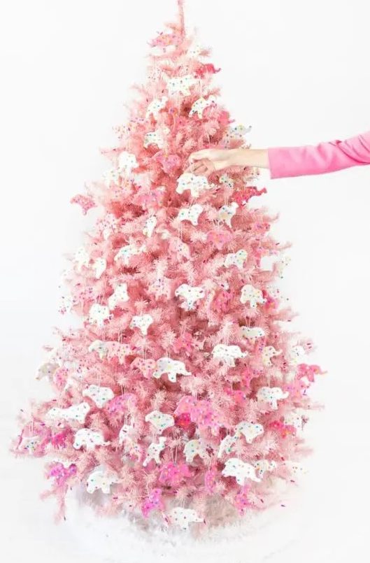 a blush Christmas tree decorated with pink and white circus animal cookie ornaments is a creative solution with color and unique ornaments