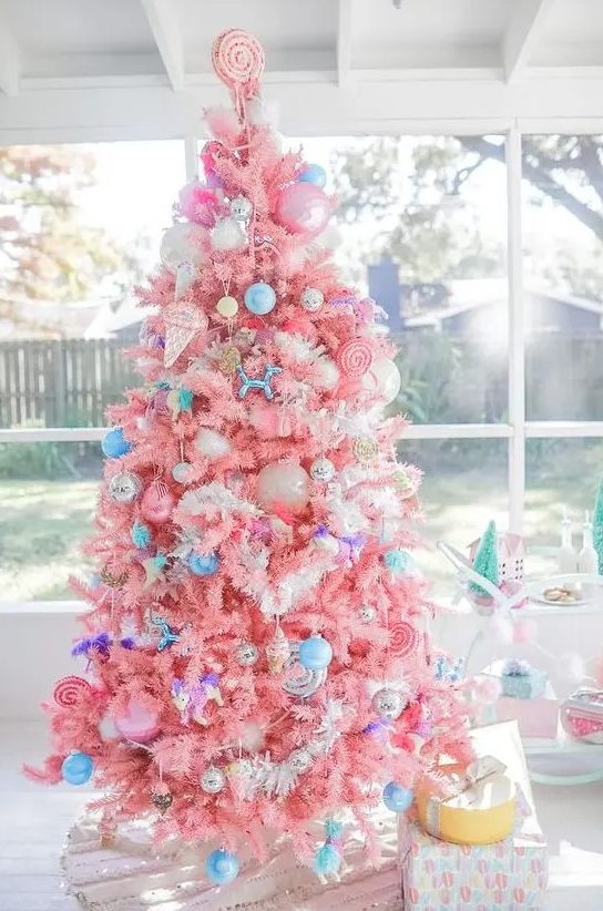 a bright candy-colored Christmas tree with bold blue ornaments, ice cream and popsicle ornaments and a candy topper