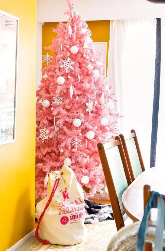 a delicate pink Christmas tree decorated with white ornaments of various looks is a tasteful and very girlish choice