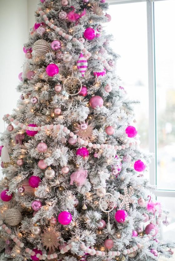 a flocked Christmas tree with silver, light and hot pink ornaments, dream catchers and lights is amazing for the holidays
