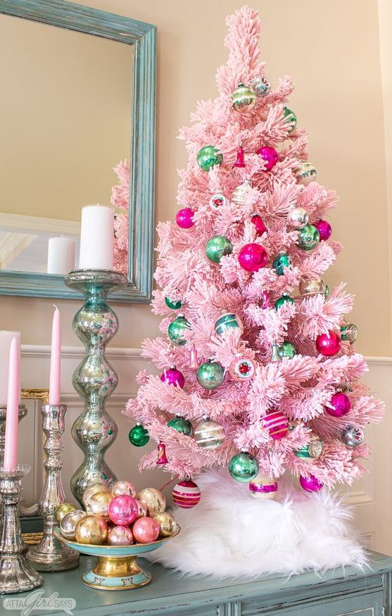 a pastel pink Christmas tree decorated with hot pink and green ornaments is a stylish vintage decor idea