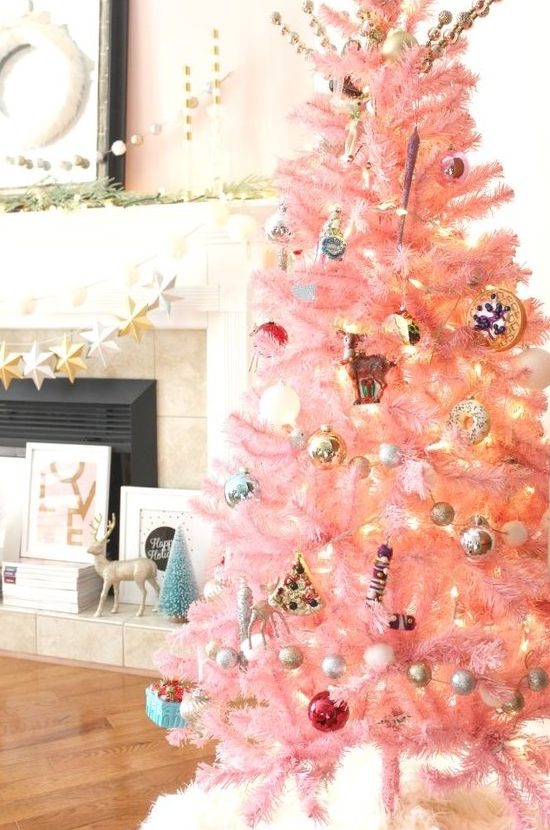 a pastel pink Christmas tree with metallic ornaments, lights and retro ones looks as a cute and chic touch of color