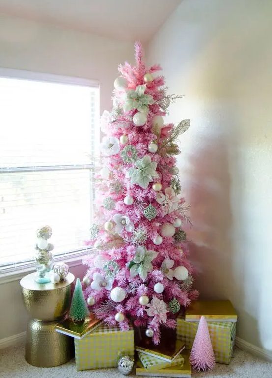 a pink Christmas tree decorated with white and gold ornaents, with fabric blooms is a stylish idea for a glam space