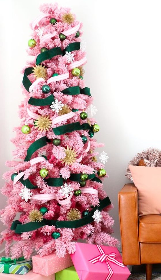 a pink Christmas tree with emerald and neutral ribbons and ornaments in various shades of green plus gold touches