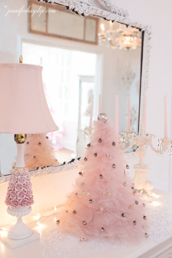 a pink ruffle Christmas tree decorated with tiny metallic ornaments adds a cool and chic glam feel to this vintage space