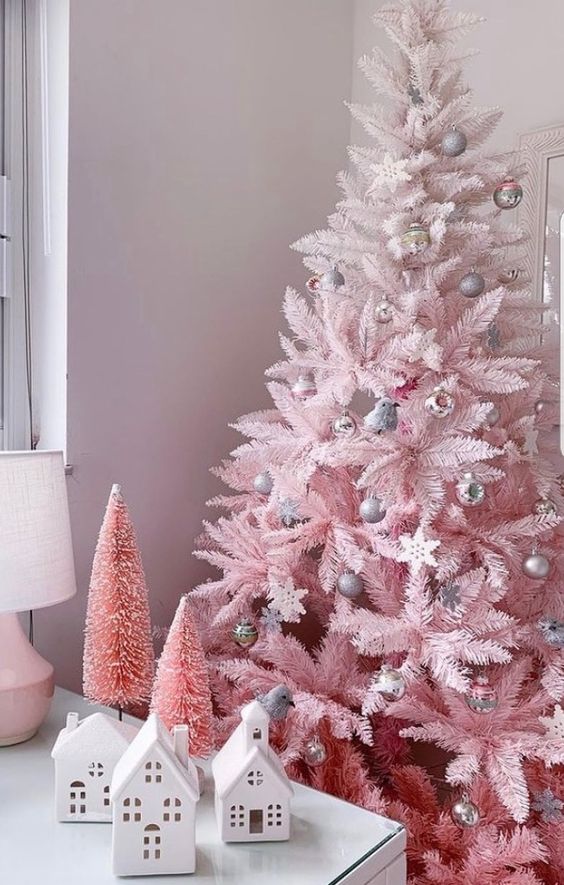 an ombre pink Christmas tree with silver ornaments of various kinds is a cool and catchy solution