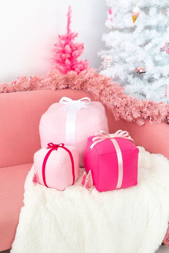 funky pink gift box holiday pillows, a pink fir garland and a hot pink mini Christmas tree decor glam and chic Christmas decor