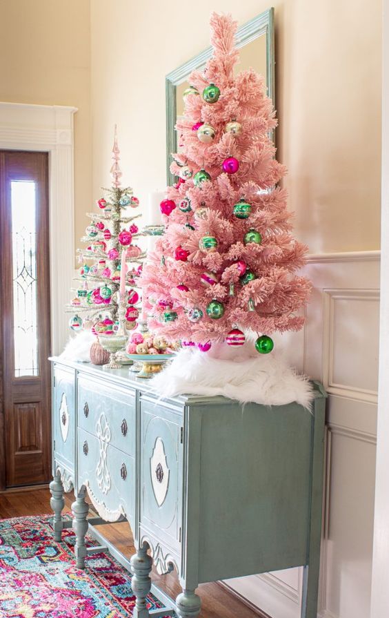 glam Christmas decor with a pink and a silver tinsel tree and green and hot pink ornaments is lovely