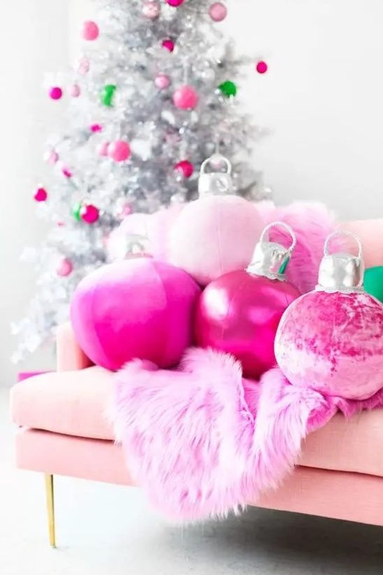 hot pink Christmas ornament pillows and a faux fur blanket plus matching ornaments on the silver Christmas tree