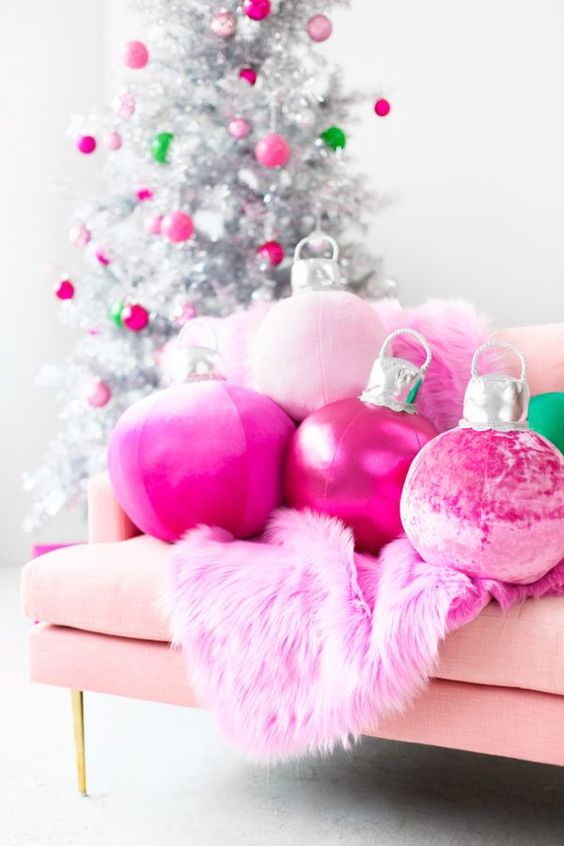 hot pink Christmas ornament pillows and a faux fur blanket plus matching ornaments on the silver Christmas tree