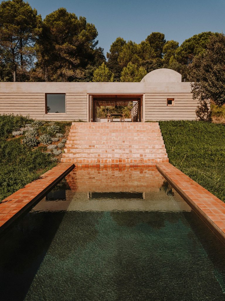 This gorgeous Catalonian house is done with sandy concrete and earthenware local tiles and looks very warm and welcoming