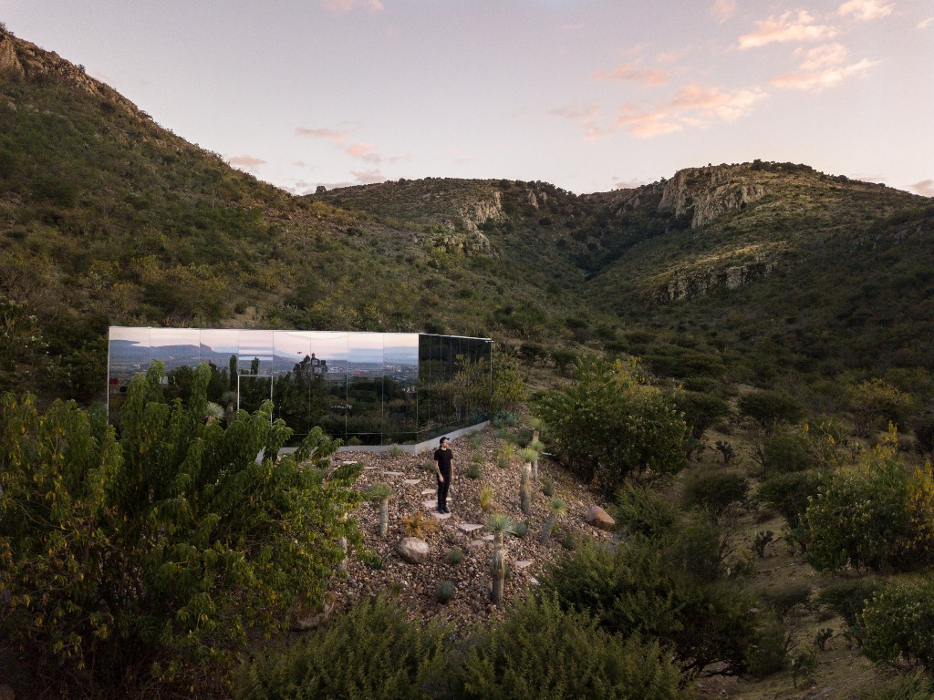 This unique off grid cabin on the slopes of a volcano is clad with mirrors to reflect the landscape