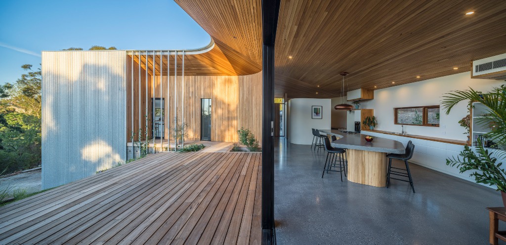 There's a long deck dotted with growing greenery and plants and the glazed facade allows the views and light