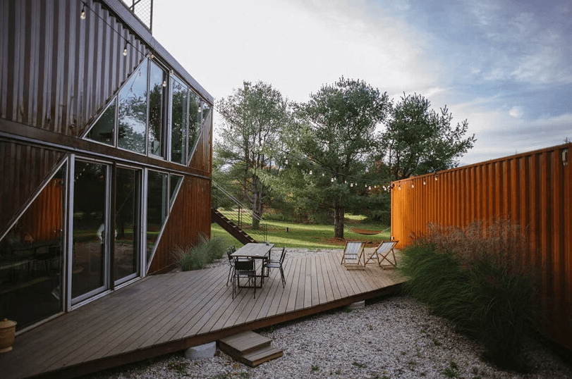 02 This is a back deck with simple furniture and grasses growing plus lights around