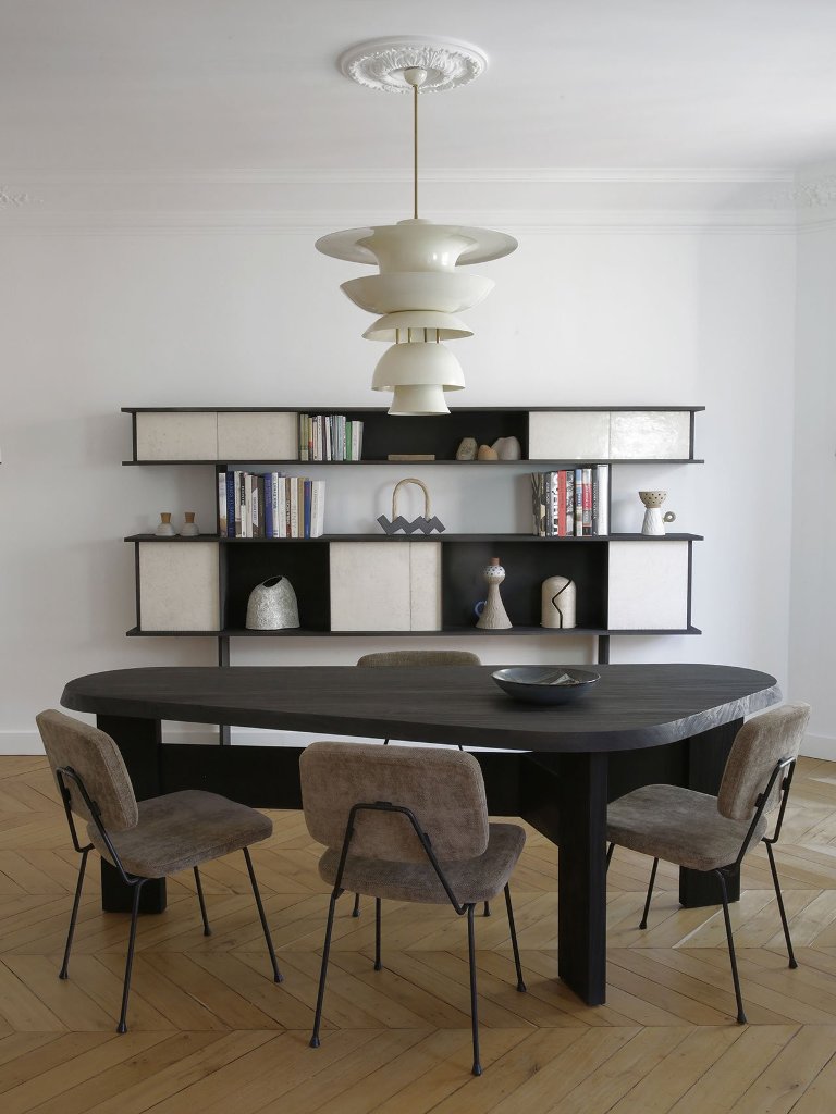 03 The dining space shows off a dark wooden table, some cool chairs and a refined storage piece at the wall