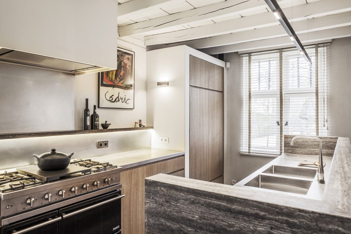 The cabinets and appliances are built-in, everything is lit up and there's a cool artwork