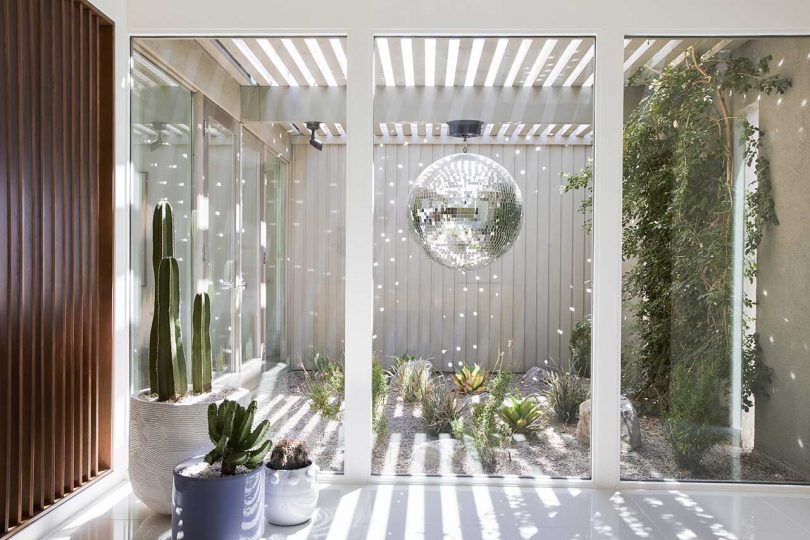 The entryway has a disco ball reflecting the light around the atrium walls