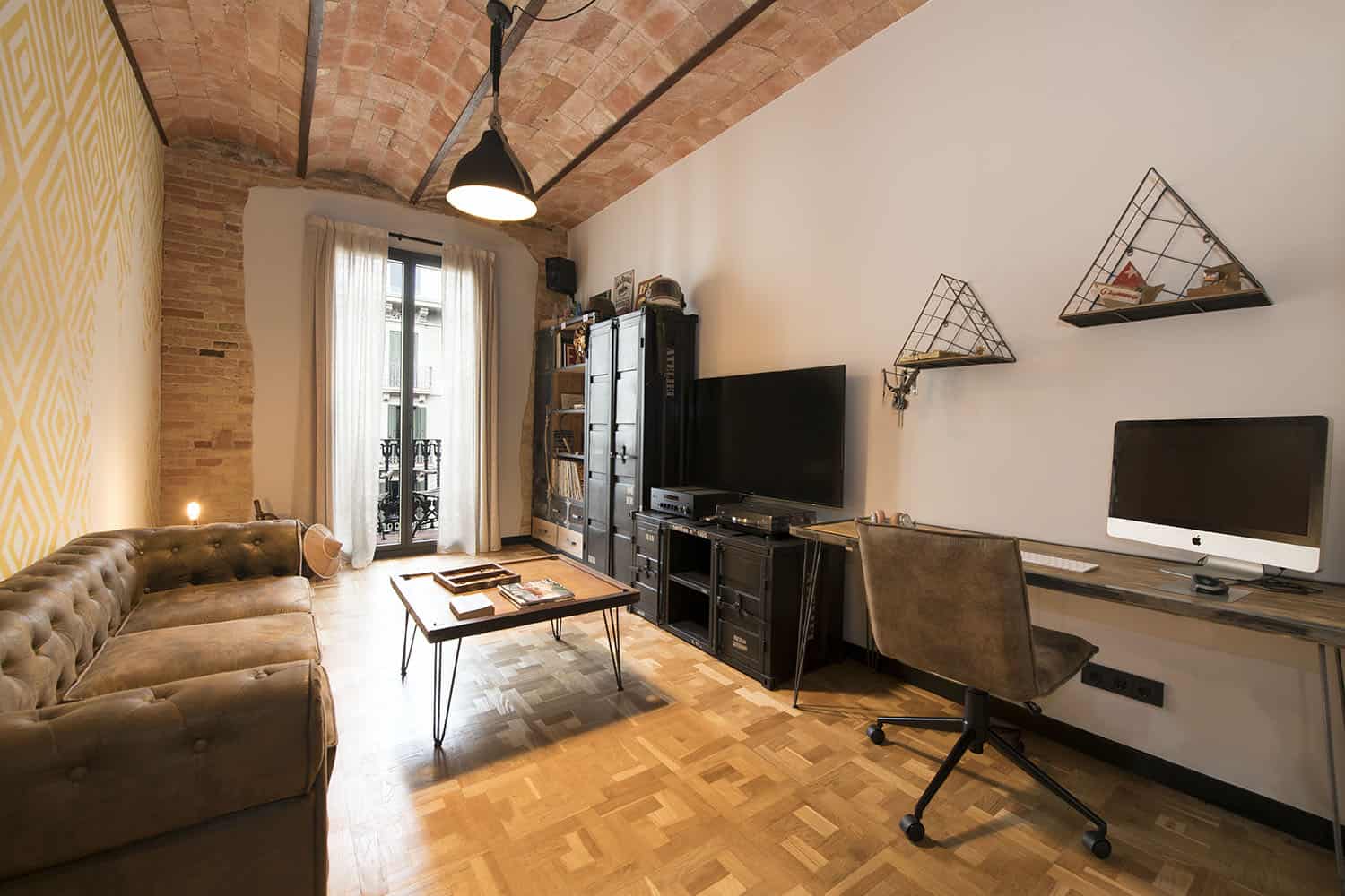 This salon is combined with a working space, there's a hairpin leg desk and some cool shelves plus storage