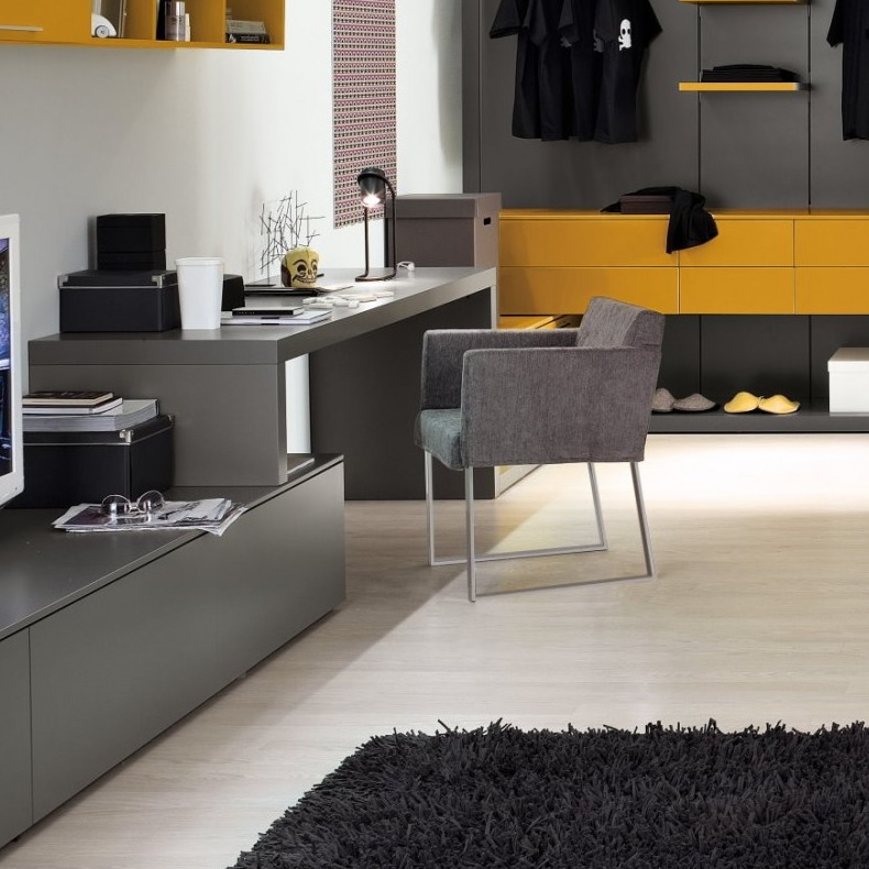 a minimalist home office with a sleek grey desk and a storage unit, a grey chair and a yellow shelf over the desk