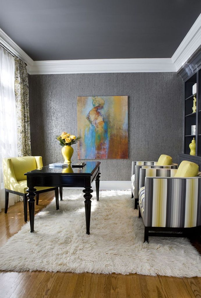 a refined home office with grey walls and a ceiling, a lemon yellow chair and striped grey and yellow ones, grey bookcases and a refined desk