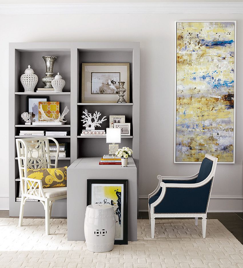 an elegant home office with dove grey walls, a built in storage unit with a built in desk, a couple of chairs and a statement artwork