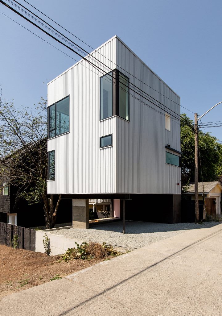The Lookout is a house raised on stilts over the street and showing off a sheltered parking space