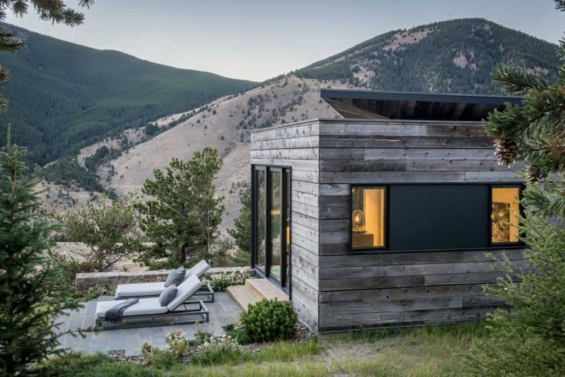 The exterior of the house is clad with wood to blend into the landscape, there are several outdoor spaces