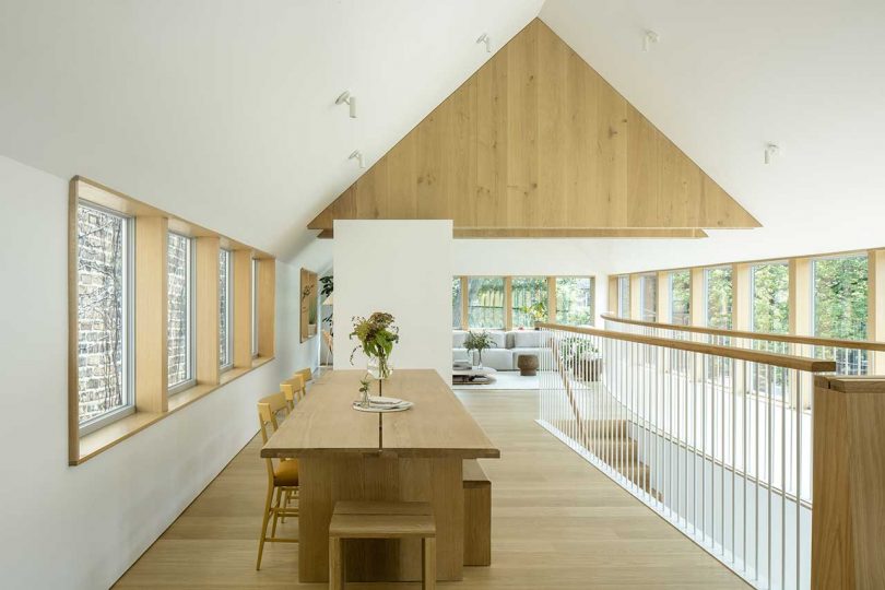 Up the stairs you may see a dining room with a wooden table and benches and a living room by the windows