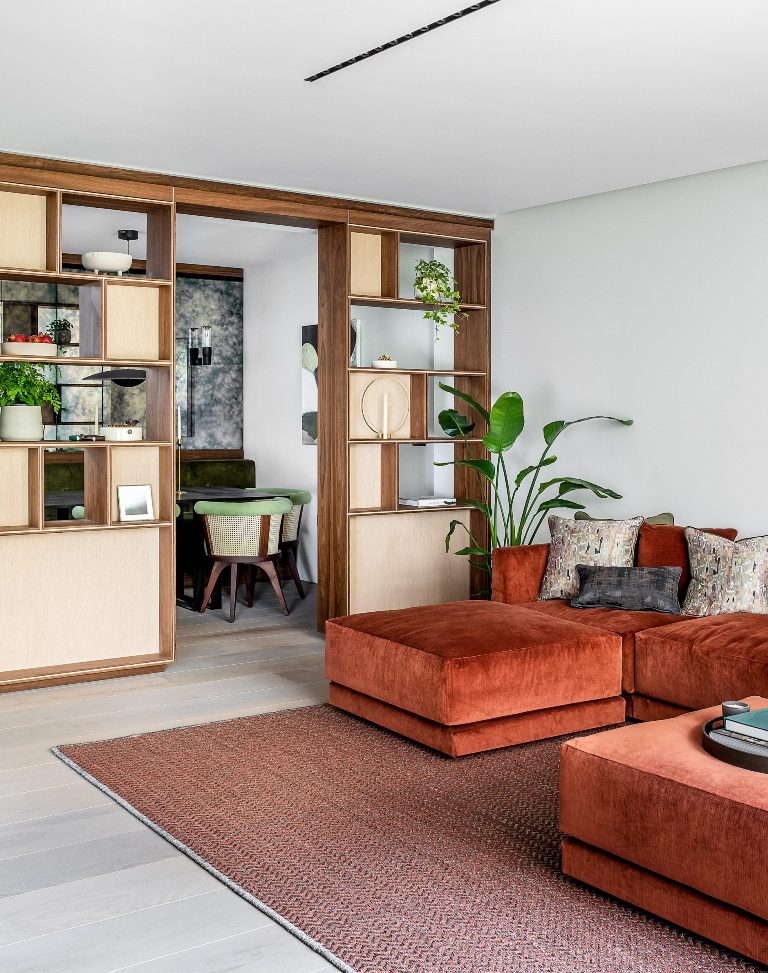 The dining space is separated with a storage unit that shows some stuff on display