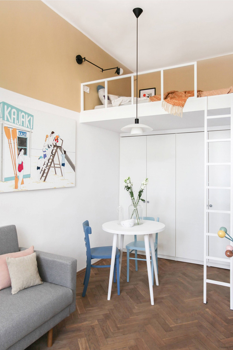 There's a small dining space, tall wardrobes and a loft bedroom with a ladder plus cool lamps