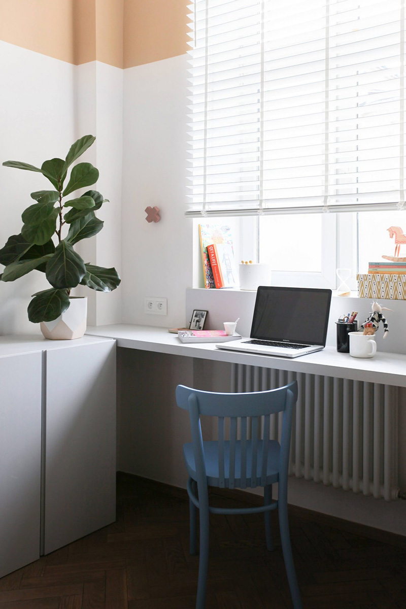 Sleek white cabinets are great for storage, and a little working space is perfectly accessorized to look nice